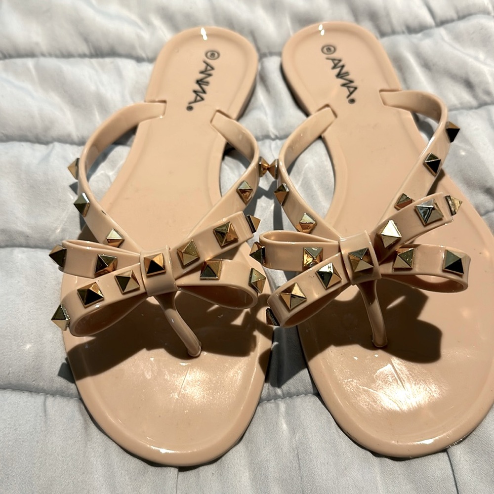 Gold studded bowtie jelly sandals